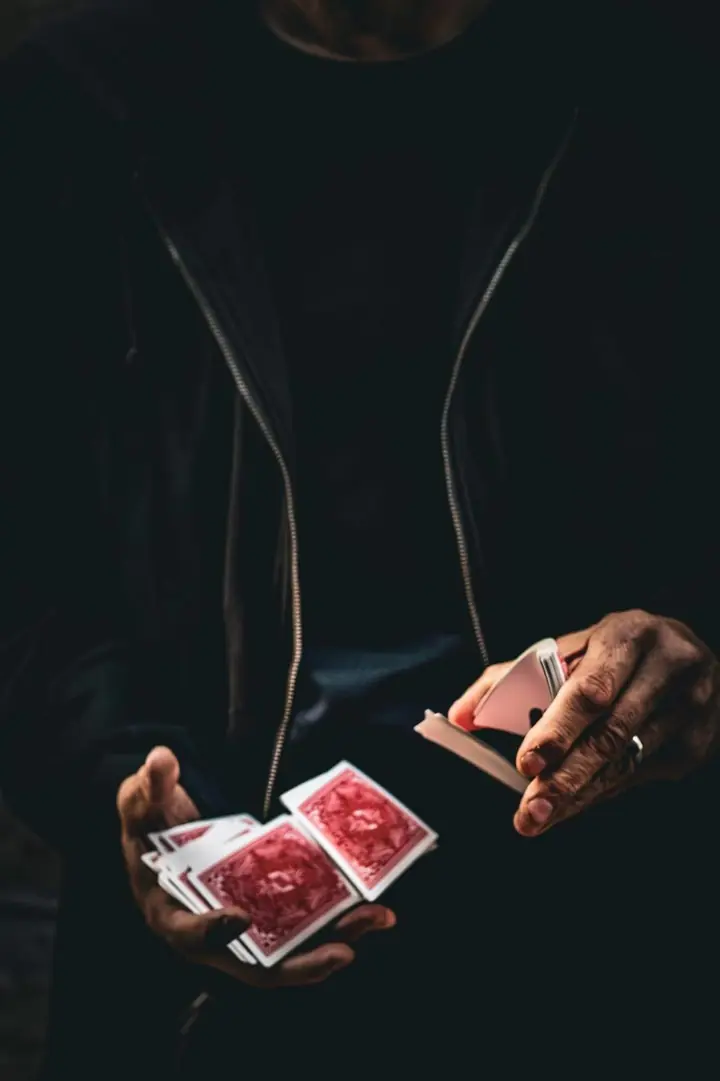 Close-up of Tripp's hands cutting a red-backed deck