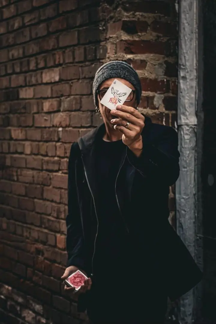 Tripp holding up a phoenix card in front of his face